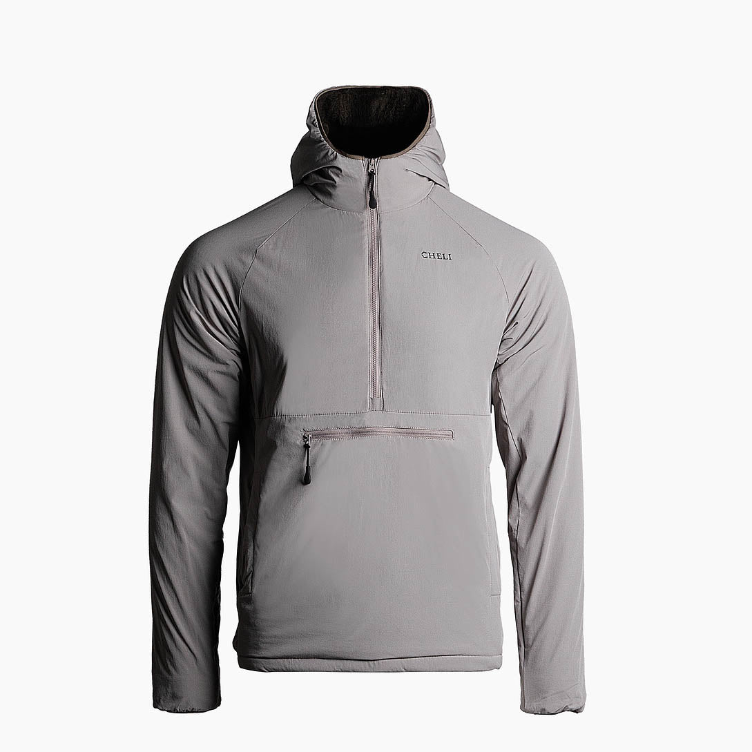 Close-up of a camouflaged jacket with zippered pocket and embroidered name.